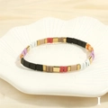 Detail of colorful enamel tile stretch bracelet with gold accents on ceramic tray - Rainbow Multicolor-I
