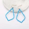 Detail of sky blue irregular geometric drop earrings on a marble tray background - Lake Blue