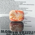 AirPods Pro case with orange and white marble texture on a glossy reflective surface - S06-Warm Yellow Agate