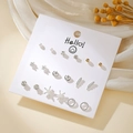 Detail of 9-pair silver earring set with pearls and rhinestones on card display - Gold Silver Star Moon Feather Wing Earrings (E1940-1)