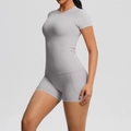 Detail view of high-waist grey yoga shorts with practical side pocket for fitness - Frost Grey
