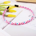 Pink fabric floral headband with colorful polka dots on a marble background - Pink with Colorful Dots
