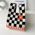 Chic knit tote bag featuring black and white checkerboard pattern with orange flower detail - Orange Flower