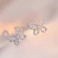 Silver butterfly stud earrings with sparkling cubic zirconia on pink silk fabric - Hollow Butterfly Style (E0484)