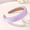 Detail of purple satin sponge headband with non-slip lining resting on glass bowl - Lavender Purple