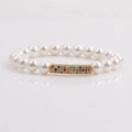 Elegant 8mm shell pearl bracelet with gold-plated zircon curved tube charm for women - White
