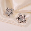 Elegant 3D textured silver flower stud earrings in titanium steel on silk fabric - Silver