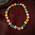 Macro detail of vintage necklace featuring colorful square stones and delicate white pearls - Necklace - Gold