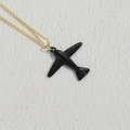 Fashionable gold necklace with a glossy black airplane pendant on a beige texture - Black (XL2377)