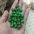 Miniature resin watermelon pendant with gold metal ring held in hand for size reference - Opened Watermelon