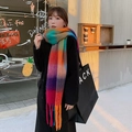 Rainbow plaid mohair scarf with soft fringe tassels worn by a model in a cozy city setting - Red Orange Blue Mix