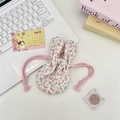 Floral fabric storage bag with rabbit ears shown on a stylish lifestyle desktop - Pink