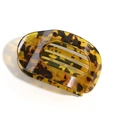 Detail view of the glossy tortoiseshell leopard print flat duckbill hair clip texture - Translucent Yellow Leopard