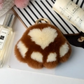 Detail of brown faux fur bear paw keychain with soft plush texture and golden metal clasp - Caramel color