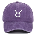 Close-up of Taurus zodiac embroidery on purple washed cotton baseball cap with ventilation eyelets - Purple
