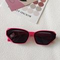 Modern hot pink geometric sunglasses with dark lenses laid on a white textured surface - Irregular Geometric Polygon