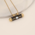 Detailed view of 3D Evil Eye cylinder pendant on a golden box chain necklace - Black