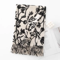 Beige faux cashmere scarf with black floral patterns and fringe details on a white surface - Twill White