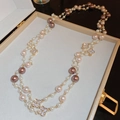 Detail of gold-plated necklace with white and brown pearls and clover charm in jewelry box - Long Zircon Flower Pearl Necklace