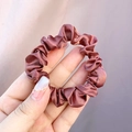 Close-up of a glossy bronze satin scrunchie with a smooth silk-like texture and elastic band - Diamond Red