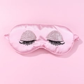 Detailed view of pink satin sleep mask with embroidered long eyelashes and glitter finish - Large Glasses Eye Mask / Pink
