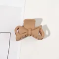 Detailed top view of a matte nude bow-shaped hair claw clip on a clean white surface - 4.5CM / 4.5cm Bowknot-Ginger Yellow