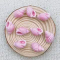 Close-up of pink spiral ceramic shell charms for DIY jewelry on a wooden tray - Light Pink