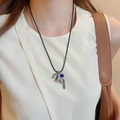 Silver elephant necklace with dark blue bead and tassel on black cord, worn on model - 29# Necklace Silver Elephant Tassel