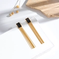 Modern rectangular tassel earrings with gold finish and black accents in natural light - ER-786 Black Rectangle Long Tassel Earrings