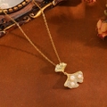 Golden ginkgo leaf necklace featuring white pearls and crystals on a vintage background - Gold Maple Leaf Pearl Style (T029)