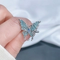 Detail of silver butterfly ring with blue enamel wings and inlaid center gemstone - Style 6 Butterfly Open Ring