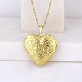 Gold heart locket necklace with floral engraving on a white display stand - Plant Pattern Heart/Gold