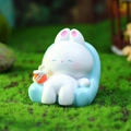 White cartoon rabbit figurine sitting on blue sofa, resin Capybara style ornament - Hot Sale Decoration Series / White Rabbit on Blue Sofa