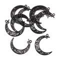 Macro shot of seven black crescent moon connectors with intricate filigree swirl patterns - Style 1 35x41mm