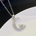 Macro shot of silver crescent moon and heart pendant necklace with cubic zirconia - Silver (8300)