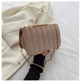 Detailed macro view of khaki velvet material with vertical striped quilting and gold chain strap - Khaki