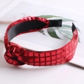 Detail view of red sequin wide headband with knotted design and holographic grid texture - Red