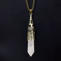 Detailed view of white crystal hexagonal point pendant with bronze filigree cap - Antique Bronze + Clear Quartz