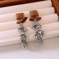 Close-up of ethnic style wooden square earrings with vintage silver tassel details - Coffee & Silver (925 Silver Pin)