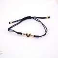 Close-up of heart-shaped charm bracelet with black pavé stones and woven cord - Black