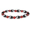 Close-up of magnetic hematite beads with polished metallic finish and red accent beads - Red Agate