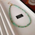 Detailed shot of Shoushan stone necklace with silver 925 tag and gold lobster clasp - Turquoise Cylindrical Bead Style