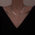 Silver double layer snake bone necklace worn by model on a minimalist black V-neck top - Double-layer Silver