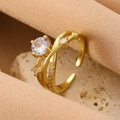 Adjustable gold bow ring with sparkling zircon stone on a natural stone surface - Gold Intertwined Zirconia Ring (K-1068)