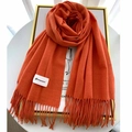 Detail of soft orange cashmere scarf with thick tassels and a brand logo label - Orange