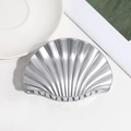 Close-up of a silver shell-shaped hair claw clip with metallic texture on white surface - Large / Silver