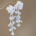 Detailed close-up of white chiffon flower earrings with delicate seed bead tassels - White