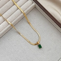 Detail of gold snake chain necklace featuring a rectangular green zircon gemstone pendant - Gold Green Zirconia