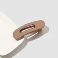 Macro shot of a matte brown large duckbill hair clip on a minimalist white ceramic plate - Matte Hair Clip Small - Beige