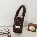 Detail of plush brown fleece cup holder bag with cream polka dots and soft texture - Brown (White Hearts)